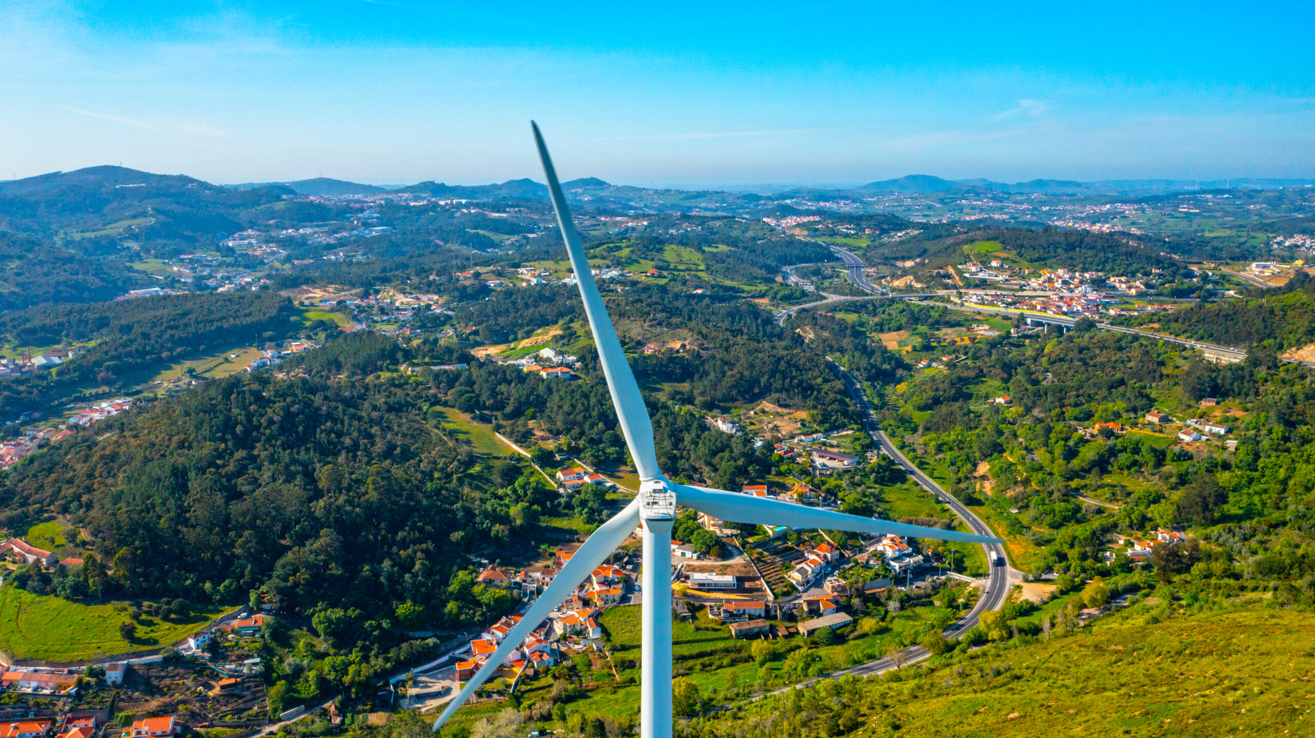 Wind turbine on the background of a small European city, a close