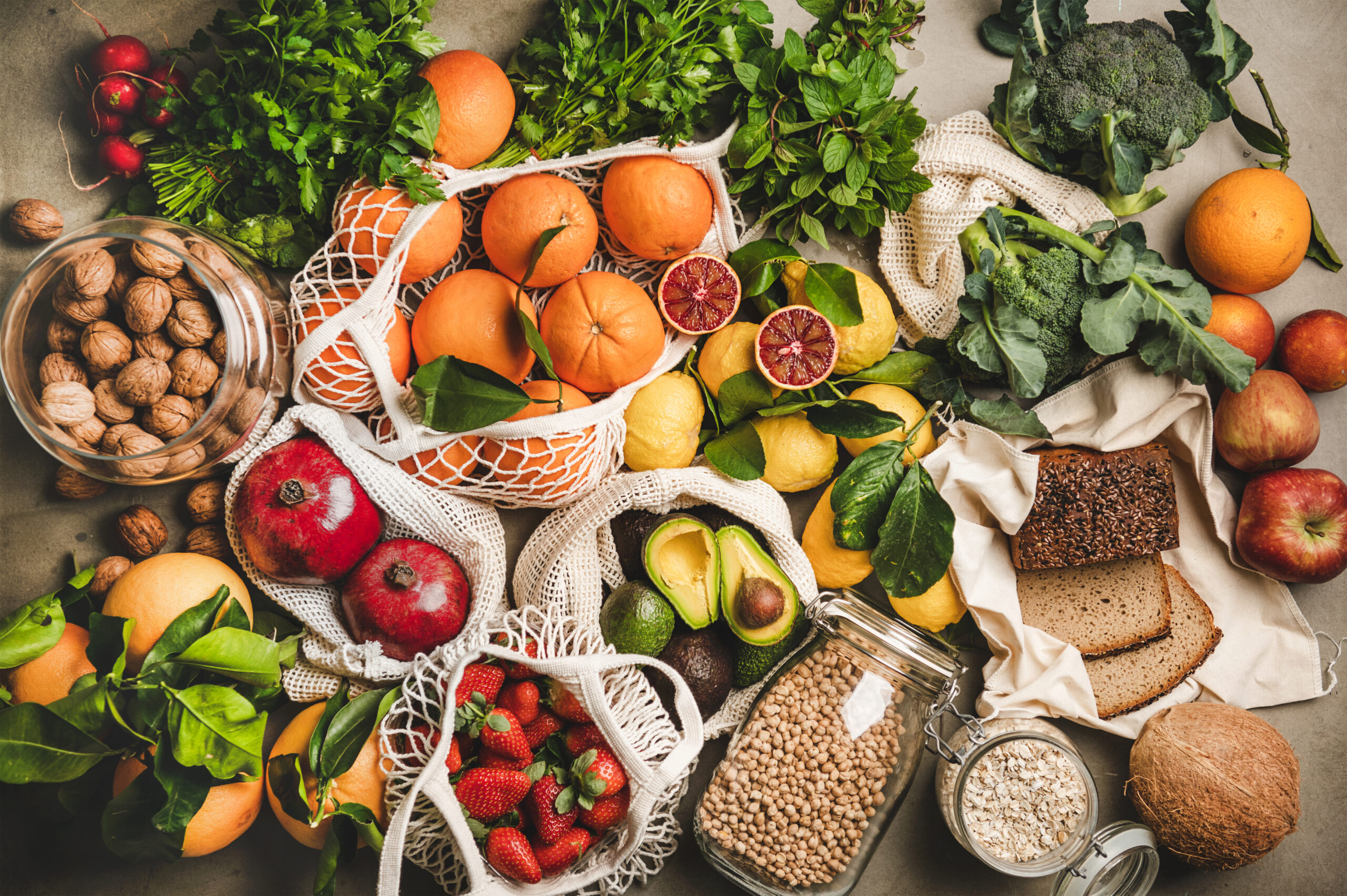 Assortment of vegan, vegetarian, balanced diet foods over grey background