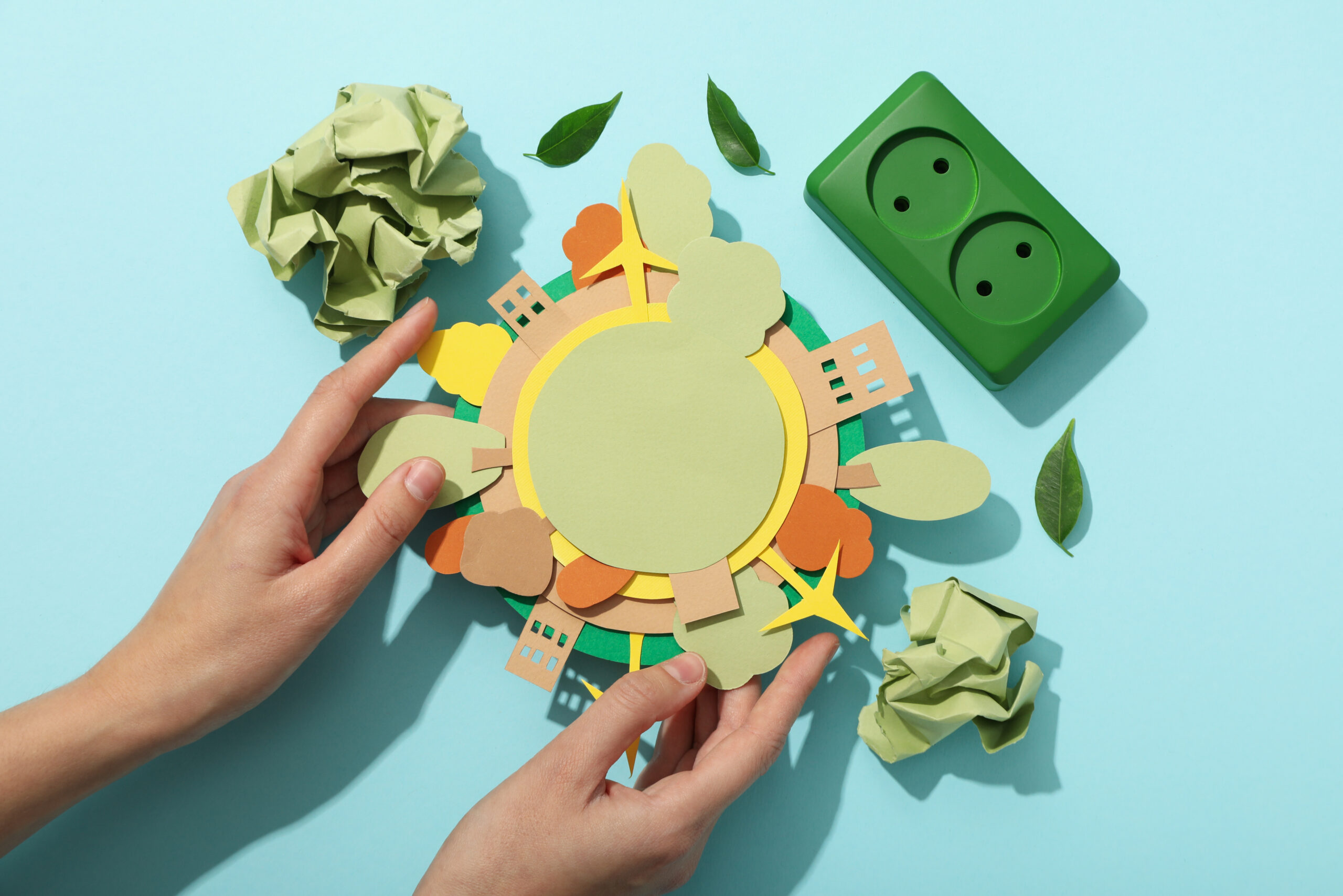 Paper model of the Earth with green electric sockets