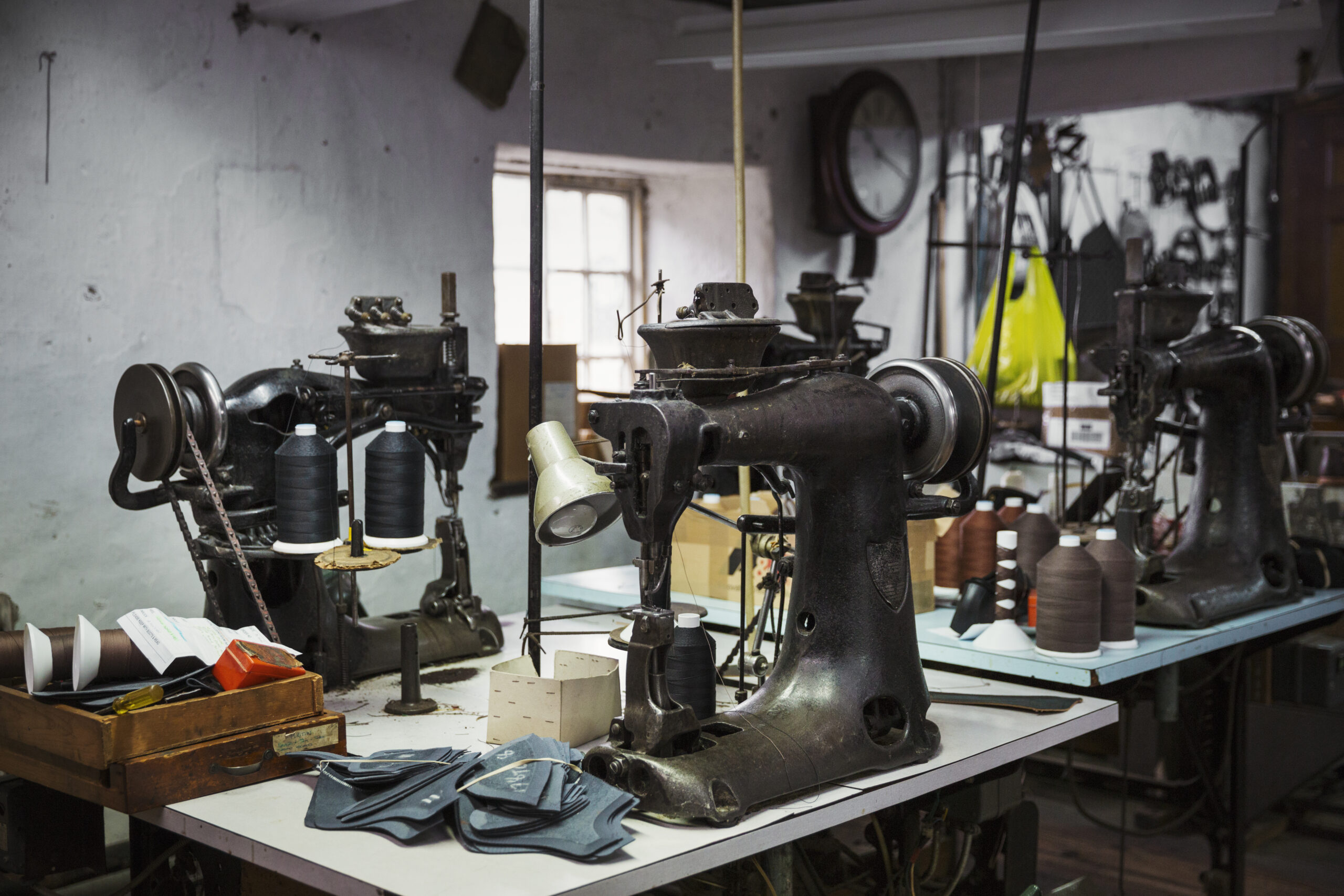 Sewing machines in a shoemaker’s workshop.,Footwear manufacture,England