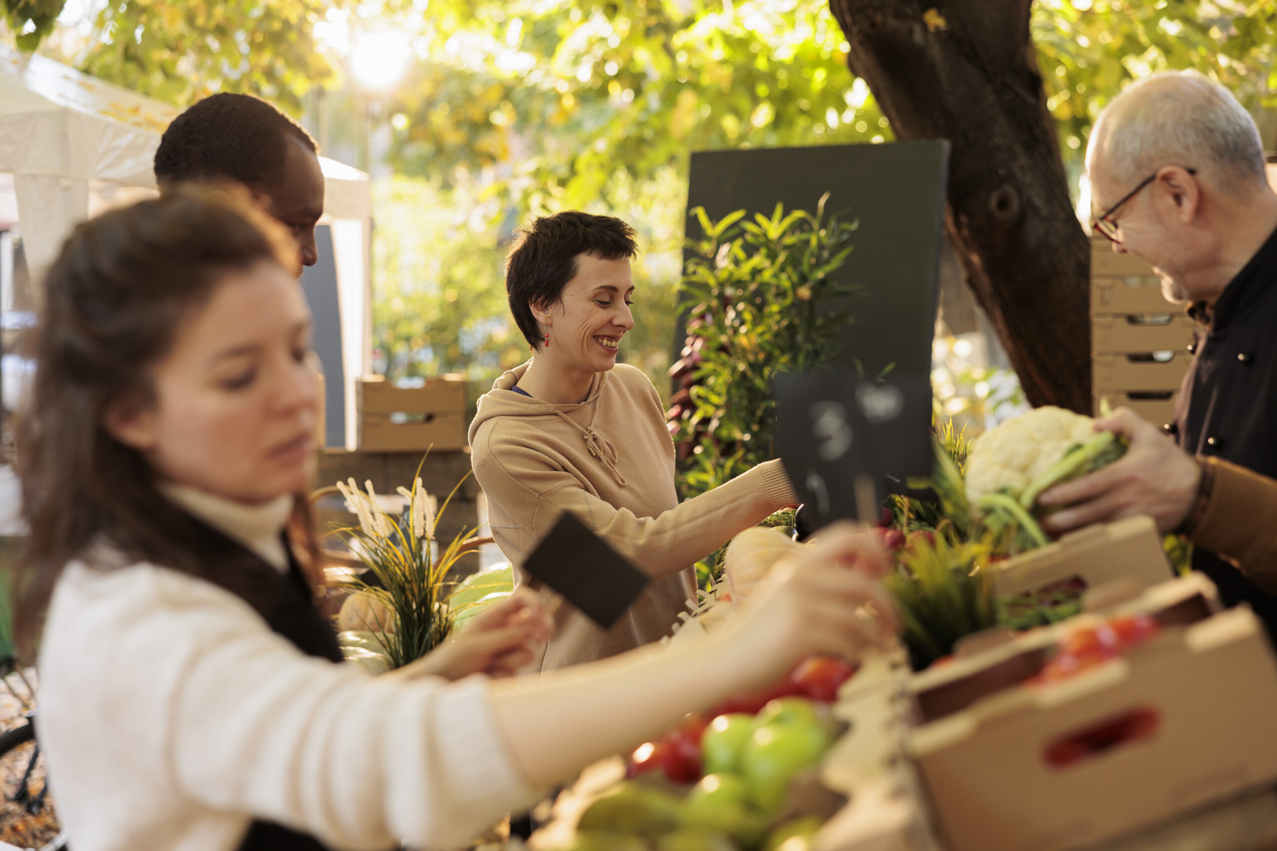 Young happy woman enjoying shopping at local farmers market